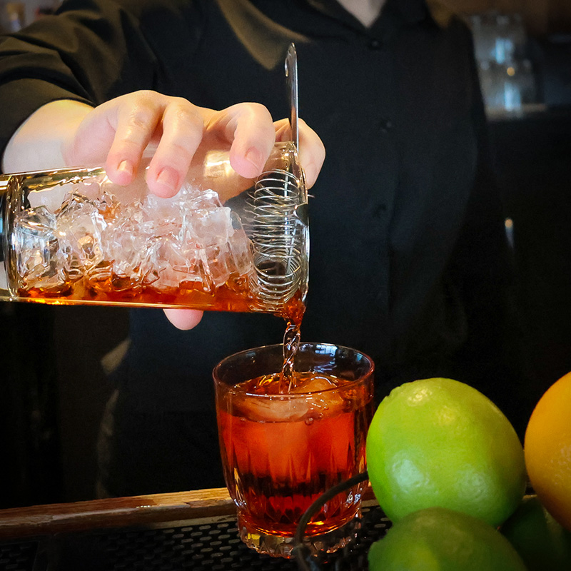 Bartender pouring a drink in the Tavern.